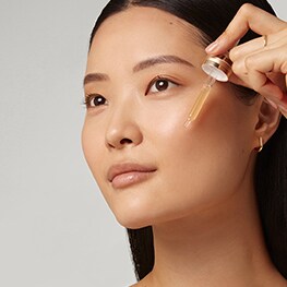 Photo of woman applying Advanced Night Repair Serum in skin cycling routine
