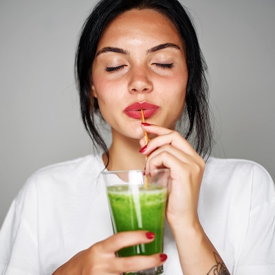 photo of woman drinking longevity smoothie